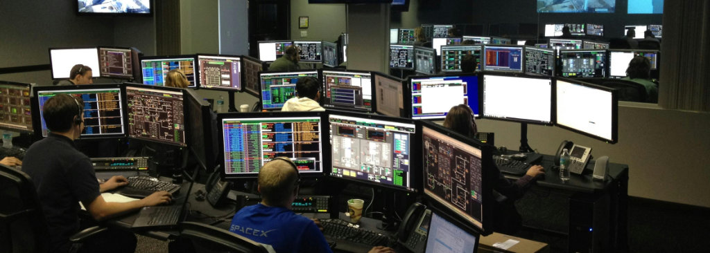 People sitting in front of computers in call center